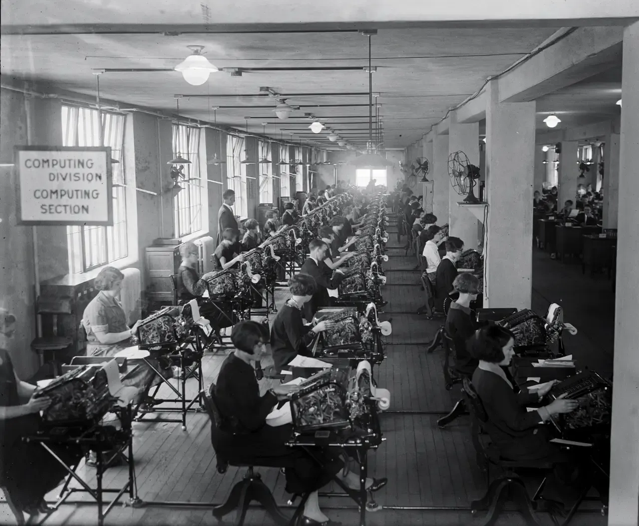 A computing division: rows of people checking calculations by hand