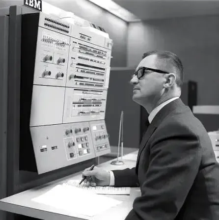 An operator checking output at an IBM console